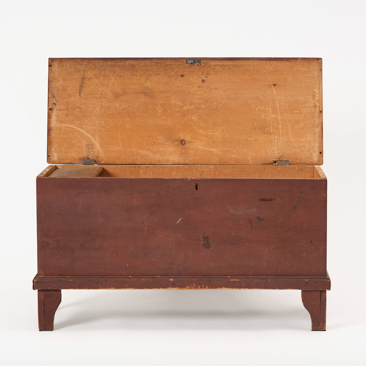 Wooden chest with a hinged lid on a white background