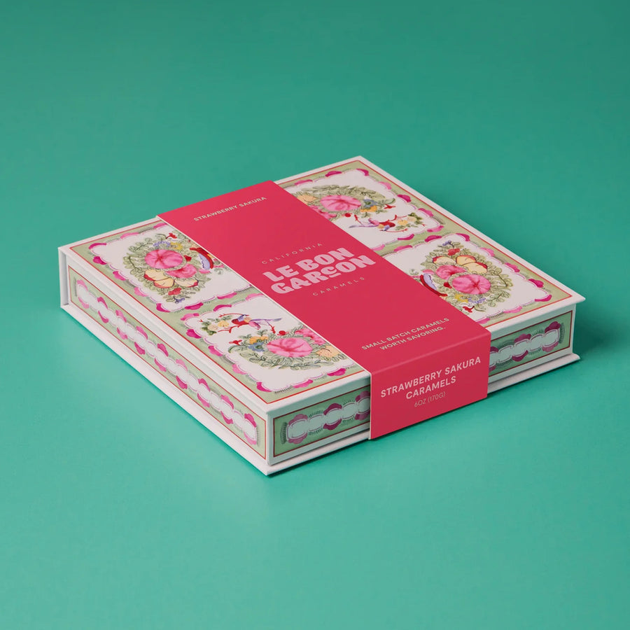 Decorative box with 'Le Bon Carreé' branding on a teal background