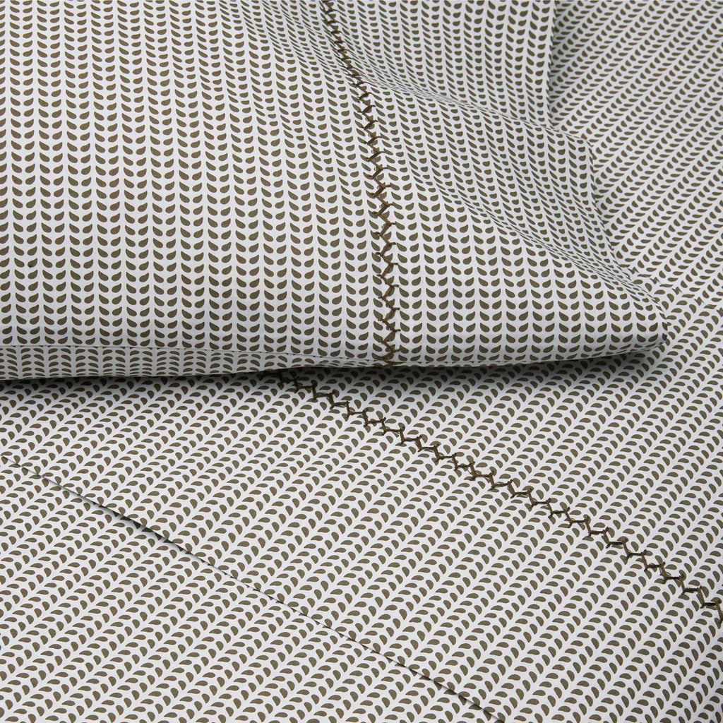 Textured fabric with a subtle pattern and visible stitching