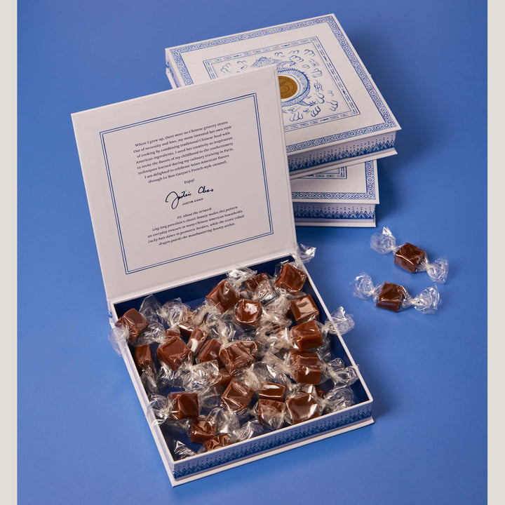 Box of caramels with a card on a blue background