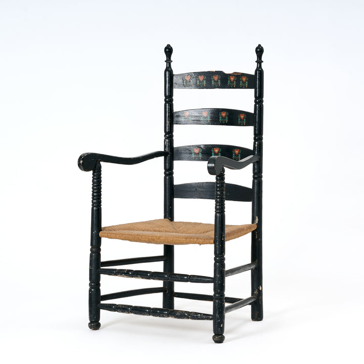 Black wooden chair with a woven seat on a white background