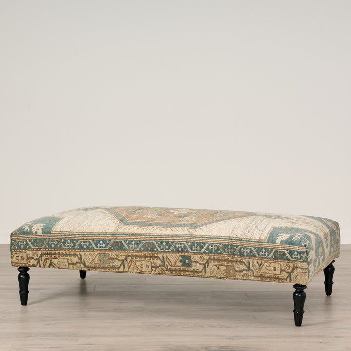Decorative bench with patterned fabric on a wooden floor.