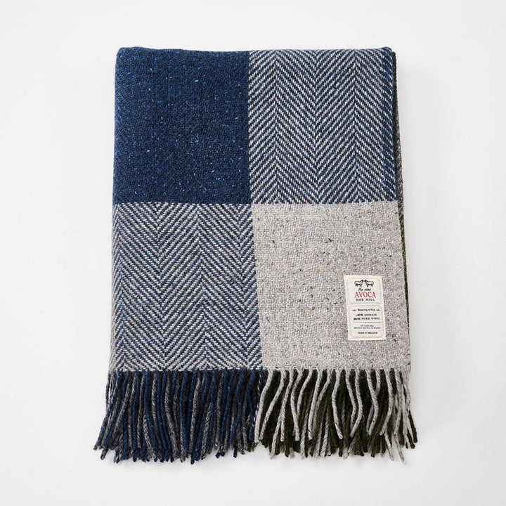 Plaid blanket with blue, gray, and white pattern on a white background