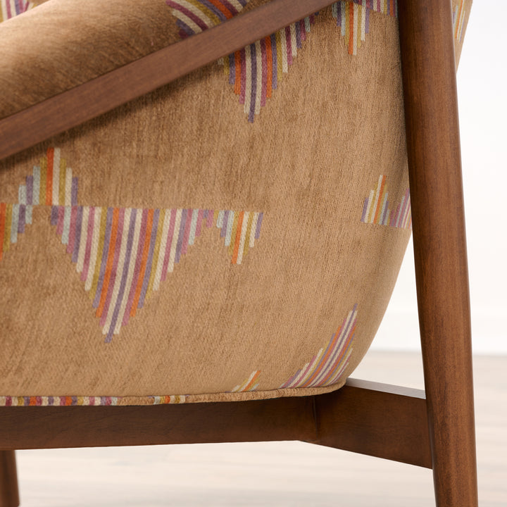 Close-up of a chair with patterned fabric and wooden frame