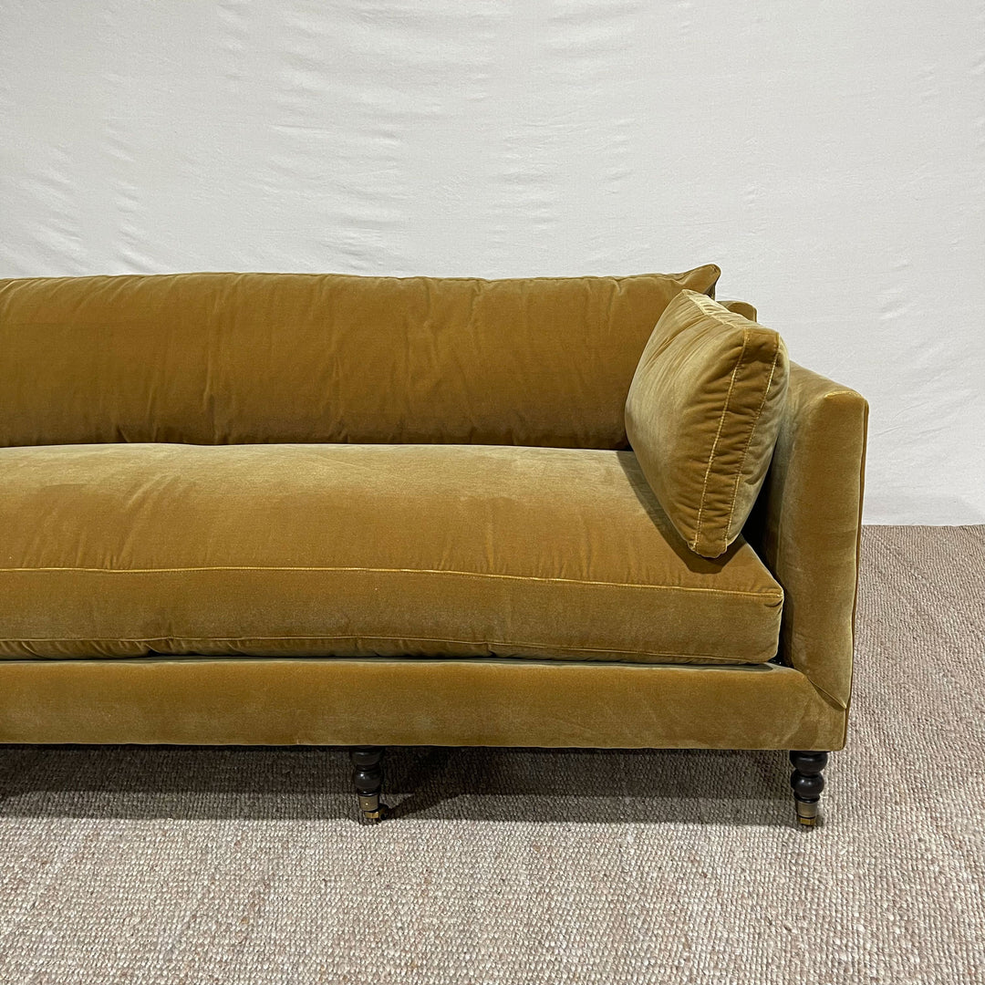 Madeilne 90” Sofa Upholstered in Harvest Brass with Cloud Down Blend Cushions and Chocolate Finish Brass Casters